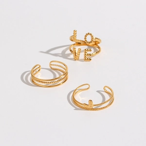 Detailed view of 3-piece gold braided ring set with LOVE lettering and heart motif