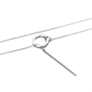 Detail of silver geometric circle and bar pendant on a stainless steel chain