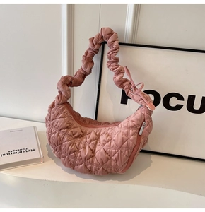 Detail of pink quilted cloud bag featuring soft fabric texture and pleated elastic strap
