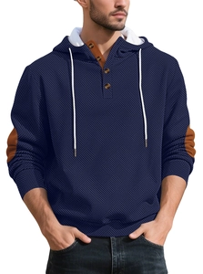 Detail of navy blue hoodie featuring 3D geometric knit texture and buttoned neckline