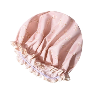 Detailed view of pink floral waterproof shower cap with elastic band and ruffled edge