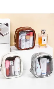 Close-up of PU leather toiletry bag with transparent window and gold zipper detail