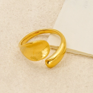 Detailed macro shot of a gold-plated fluid open ring with a smooth polished finish