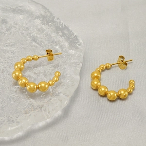 Detailed view of vintage 18k gold plated stainless steel beaded half-hoop earrings