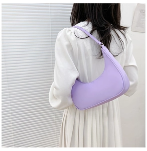Close-up of a lavender nylon crescent bag worn as an underarm shoulder bag