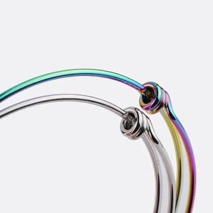 Macro detail of adjustable 1.8mm stainless steel coil bracelets in silver and rainbow tones