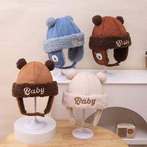 Detail of four colorful baby bear earflap hats with plush lining and chin straps