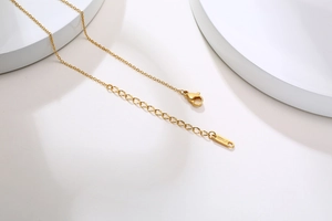 Detailed view of the 18KGP gold lobster clasp and extension chain on a necklace