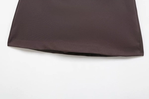 Detailed view of the dark brown skirt hemline showing fine stitching and woven texture