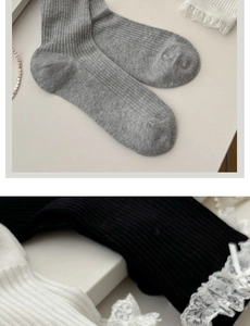 Detailed view of women's ribbed cotton socks with delicate lace trim and bow knot details