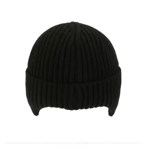 Detail view of the back of a black rib-knit winter hat with thermal ear protection