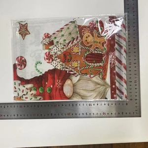 Detailed view of 40x30cm linen Christmas placemat with Santa and gingerbread house print