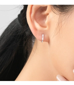 Close-up of S925 sterling silver hoop earring with enamel inlay and sparkling stones