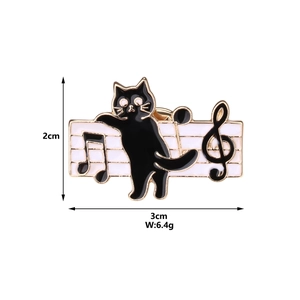 Detail shot of black enamel cat music brooch showing 3cm width and 2cm height dimensions