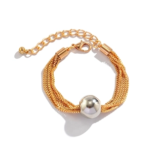 Detail of layered gold chain necklace with a large silver spherical bead and clasp