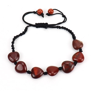 Detailed view of hand-woven heart-shaped red jasper stone beaded bracelet with adjustable cord
