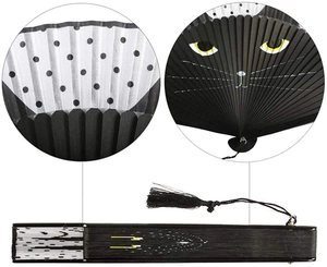 Close-up of a Japanese cat folding fan with black bamboo ribs and a black tassel charm