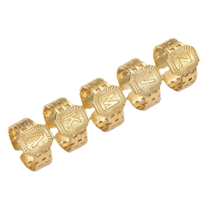 Set of gold stainless steel initial rings with square embossed alphabet letters on white