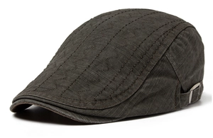 Detail view of cotton texture and wave decorative stitching on brown flat cap