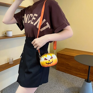 Detailed outdoor view of the pumpkin-shaped crossbody bag with adjustable strap