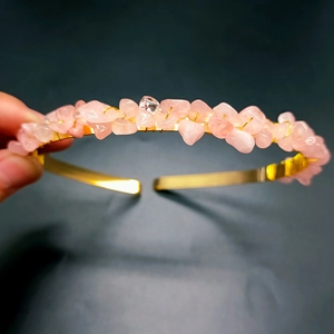 Detail of pink crystal stones hand-wrapped on a golden bridal crown headband
