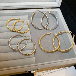 Minimalist textured hoop earrings set in gold and silver finish with diamond pattern