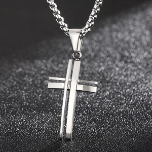 Detailed view of silver hollowed double-layer cross pendant with sturdy box chain