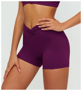 Detailed view of dark purple high-waisted yoga shorts with seamless V-cross waist design