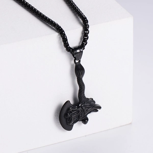 Matte black stainless steel dragon axe pendant necklace on minimalist white stone