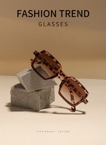 Detail of tortoise shell square sunglasses with brown gradient lenses on stone props