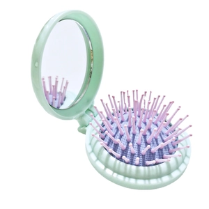 Portable mint green folding mirror and purple air cushion hairbrush travel kit