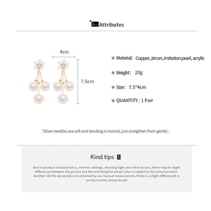 Tableau des tailles détaillé des boucles d'oreilles fleurs et perles sur fond blanc