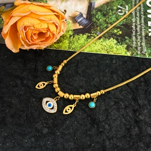 Golden stainless steel snake chain necklace with devil eye pendant and turquoise beads