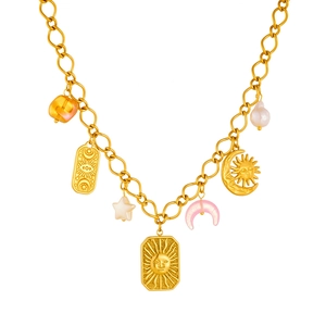 Gold-plated chain necklace featuring sun, moon, star charms and baroque pearl on white background
