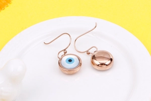 Macro shot of rose gold evil eye hook earrings showing polished front and back details