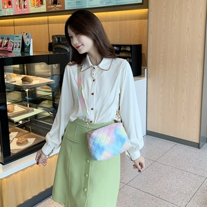 Quilted gradient shoulder bag with colorful diamond stitching worn by a model
