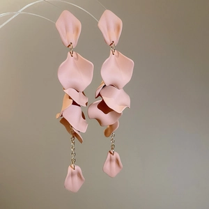 Detailed close-up of pink layered petal tassel earrings with golden chain for women