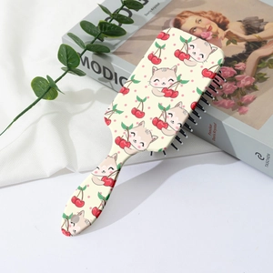 Detail of cute cat and cherry print hair brush featuring a round hanging hole handle