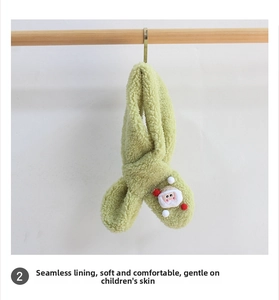 Detail of green fleece scarf featuring a Santa patch and soft bone-free inner lining