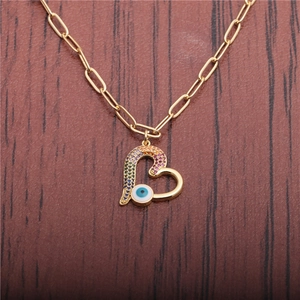 Golden paperclip chain necklace with a heart pendant featuring colorful zircons and evil eye