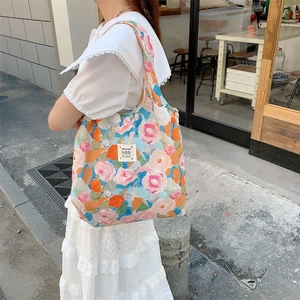 Dettaglio della borsa tote in tela con stampa floreale a olio ed etichetta Love