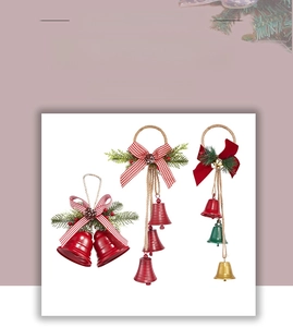 Detail of vintage Christmas bells with pine needles, cones and plaid bows for tree decor