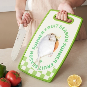 Double-sided food grade plastic cutting board with fruit patterns and a white kitchen knife