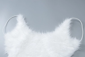 Detailed close-up of white plush texture and fabric quality on the backless party dress