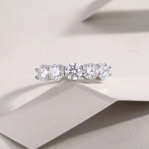 Macro view of a silver S925 band featuring five round-cut sparkling moissanite stones