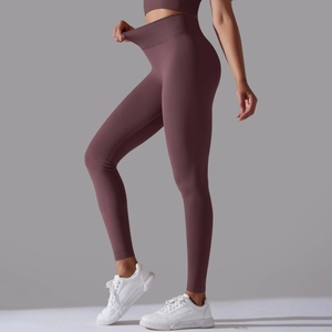 Detail of high-waist yoga pants with wide ribbed waistband and stretchy seamless fabric