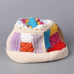 Detail view of the colorful hand-crocheted texture and vibrant bohemian stitch patterns