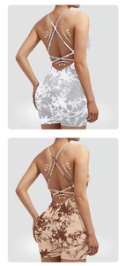 Detail view of back cross-strap design and body-shaping support on tie-dye yoga bodysuit