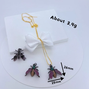 Golden insect jewelry set with bee necklace and earrings featuring colored gemstones