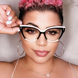 Front close-up of cat-eye glasses with black and white contrast frame and metal rivets